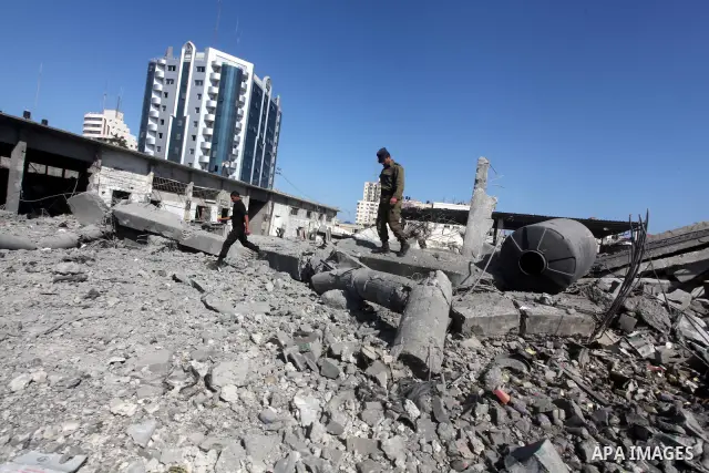 Palestinian Hamas security personnel inspect the damage at al-Saraya Security complex in the centre of Gaza City on June 23, 2012 as Israel launched fresh air strikes on the Gaza Strip overnight after killing two people...