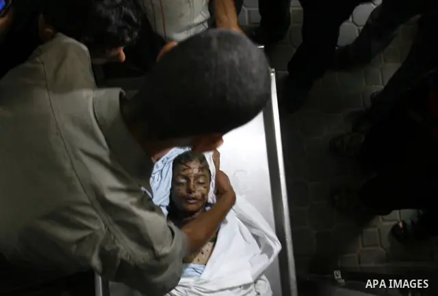 The body of a Palestinian six-year-old boy Ali Al-Shwaf is shown to the media as they prepare his body for burial at the Nasser hospital morgue in Khan Younis, in the southern Gaza Strip June 23, 2012. Hamas medical offi...