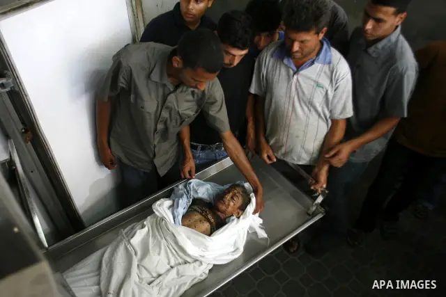 The body of a Palestinian six-year-old boy Ali Al-Shwaf is shown to the media as they prepare his body for burial at the Nasser hospital morgue in Khan Younis, in the southern Gaza Strip June 23, 2012. Hamas medical offi...