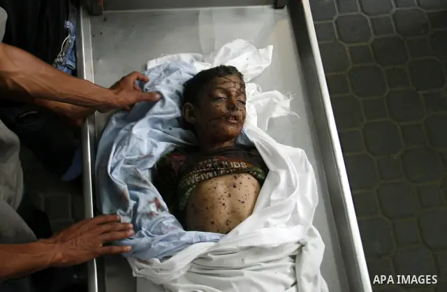 The body of a Palestinian six-year-old boy Ali Al-Shwaf is shown to the media as they prepare his body for burial at the Nasser hospital morgue in Khan Younis, in the southern Gaza Strip June 23, 2012. Hamas medical offi...