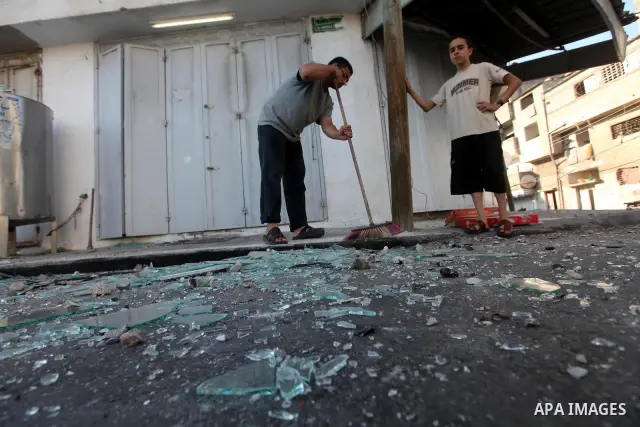 Palestinians inspect the damage in his shop near al-Saraya Security complex in the centre of Gaza City on June 23, 2012 as Israel launched fresh air strikes on the Gaza Strip overnight after killing two people in earlier...