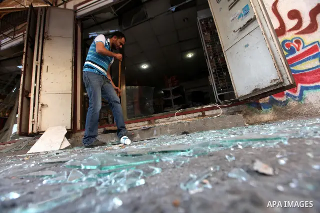 A Palestinian man inspects the damage in his shop near al-Saraya Security complex in the centre of Gaza City on June 23, 2012 as Israel launched fresh air strikes on the Gaza Strip overnight after killing two people in e...