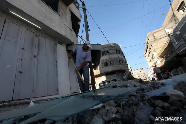 A Palestinian man inspects the damage in his shop near al-Saraya Security complex in the centre of Gaza City on June 23, 2012 as Israel launched fresh air strikes on the Gaza Strip overnight after killing two people in e...
