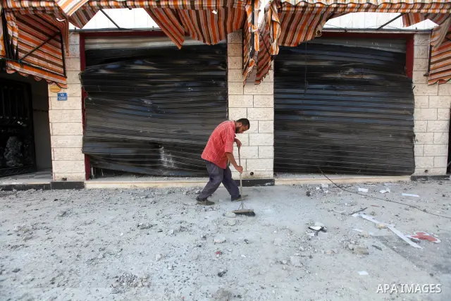 A Palestinian man inspects the damage in his shop near al-Saraya Security complex in the centre of Gaza City on June 23, 2012 as Israel launched fresh air strikes on the Gaza Strip overnight after killing two people in e...