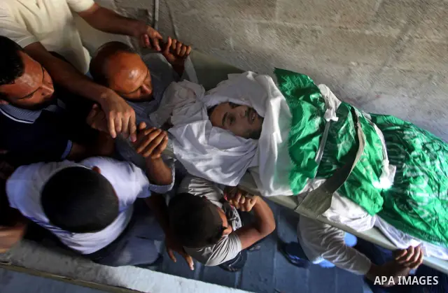 Palestinian mourners carry the body of Khaled al-Burai, 25-years-old, killed in an Israeli drone strike, during his funeral in the Jabalia refugee camp in the northern Gaza Strip on June 23, 2012. The armed wing of Hamas...
