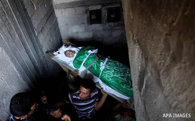 Palestinian mourners carry the body of Khaled al-Burai, 25-years-old, killed in an Israeli drone strike, during his funeral in the Jabalia refugee camp in the northern Gaza Strip on June 23, 2012. The armed wing of Hamas...