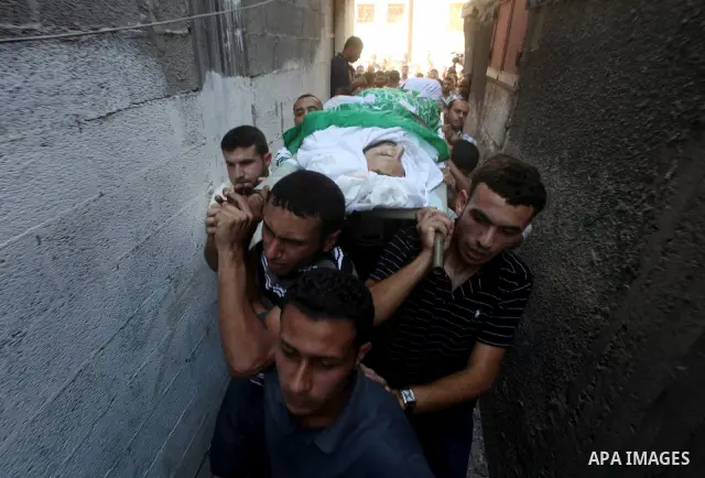 Palestinian mourners carry the body of Khaled al-Burai, 25-years-old, killed in an Israeli drone strike, during his funeral in the Jabalia refugee camp in the northern Gaza Strip on June 23, 2012. The armed wing of Hamas...