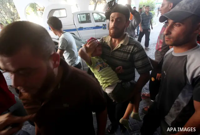 Palestinians wheel a wounded man at a hospital in Gaza City, following an Israeli air strike June 23, 2012. Israeli air strikes on Hamas security targets in Gaza killed two Palestinians and wounded 30 people on Saturday,...