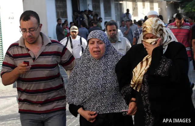 Palestinian relatives of Osama Ali grieves at the morgue after the teenager was killed in an Israeli strike on Gaza City on June 23, 2012. The Palestinian teenager riding a motorcycle was killed, and 10 passers-by wounde...