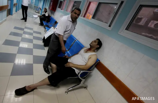 A Palestinian medic wheels a wounded man at a hospital in Gaza City, following an Israeli air strike June 23, 2012. Israeli air strikes on Hamas security targets in Gaza killed two Palestinians and wounded 30 people on S...