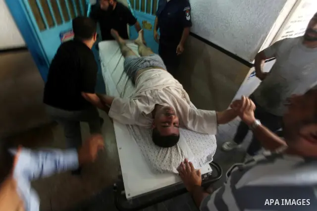 A Palestinian medic wheels a wounded man at a hospital in Gaza City, following an Israeli air strike June 23, 2012. Israeli air strikes on Hamas security targets in Gaza killed two Palestinians and wounded 30 people on S...