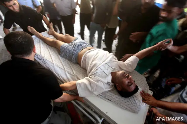 A Palestinian medic wheels a wounded man at a hospital in Gaza City, following an Israeli air strike June 23, 2012. Israeli air strikes on Hamas security targets in Gaza killed two Palestinians and wounded 30 people on S...