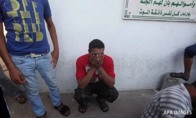 Palestinian relatives of Osama Ali grieves at the morgue after the teenager was killed in an Israeli strike on Gaza City on June 23, 2012. The Palestinian teenager riding a motorcycle was killed, and 10 passers-by wounde...