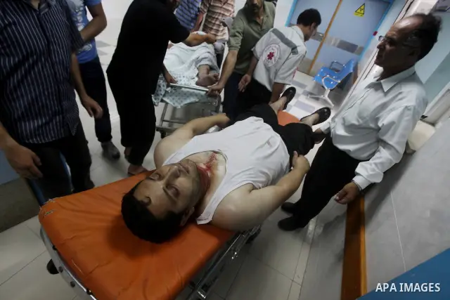 A Palestinian medic wheels a wounded man at a hospital in Gaza City, following an Israeli air strike June 23, 2012. Israeli air strikes on Hamas security targets in Gaza killed two Palestinians and wounded 30 people on S...