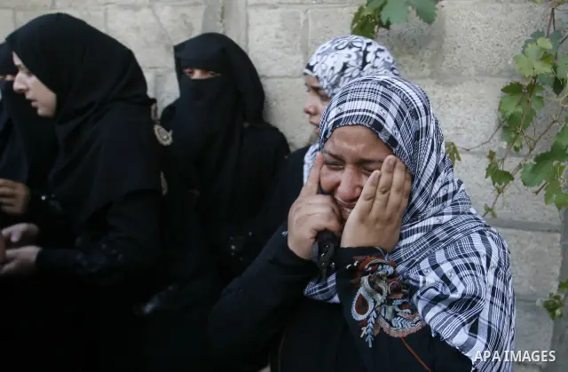 Palestinian relatives mourn during the funeral procession of six-year-old Ali al-Shwaf in Khan Younis, in the southern Gaza Strip on June 23, 2012, after he was killed during an Israeli air strike in Gaza and his father...
