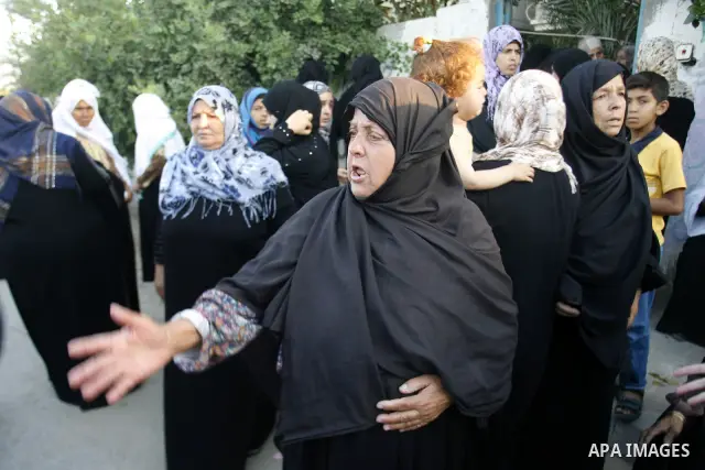 Palestinian relatives mourn during the funeral procession of six-year-old Ali al-Shwaf in Khan Younis, in the southern Gaza Strip on June 23, 2012, after he was killed during an Israeli air strike in Gaza and his father...