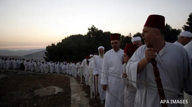 Samaritans attend Shavuot festival on Mount Gerizim near the northern West Bank city of Nablus on June 24, 2012 which is giving of the Torah at Mount Sinai seven weeks after the exodus of the Jewish people from Egypt. Th...