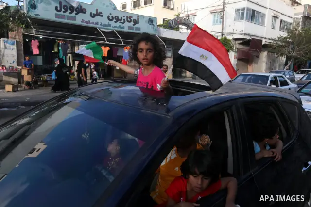 Palestinians hold national and Egyptian flags as they celebrate in Gaza City, the victory of Muslim Brotherhood's presidential candidate, Mohamed Morsi, in the Egyptian elections on June 24, 2012. Arab governments and le...