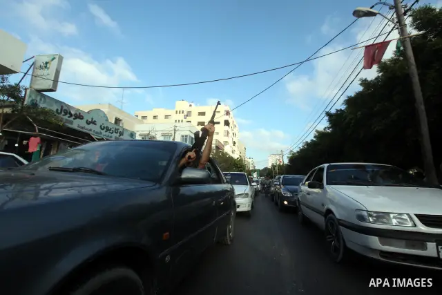 Palestinians hold national and Egyptian flags as they celebrate in Gaza City, the victory of Muslim Brotherhood's presidential candidate, Mohamed Morsi, in the Egyptian elections on June 24, 2012. Arab governments and le...