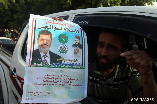Palestinians hold national and Egyptian flags as they celebrate in Gaza City, the victory of Muslim Brotherhood's presidential candidate, Mohamed Morsi, in the Egyptian elections on June 24, 2012. Arab governments and le...