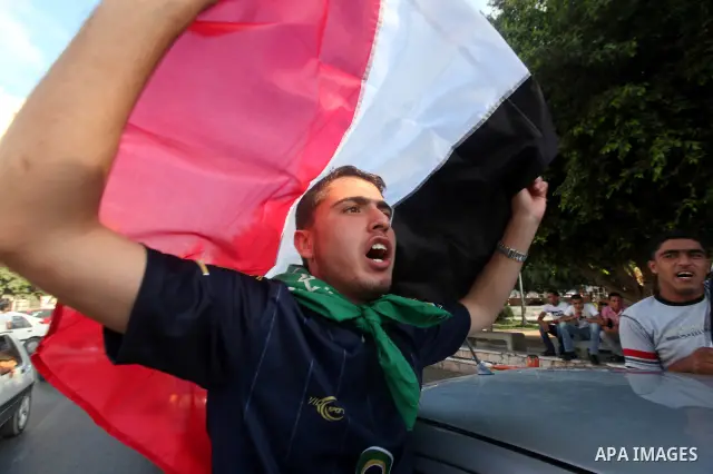 Palestinians hold national and Egyptian flags as they celebrate in Gaza City, the victory of Muslim Brotherhood's presidential candidate, Mohamed Morsi, in the Egyptian elections on June 24, 2012. Arab governments and le...