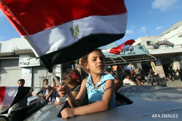 Palestinians hold national and Egyptian flags as they celebrate in Gaza City, the victory of Muslim Brotherhood's presidential candidate, Mohamed Morsi, in the Egyptian elections on June 24, 2012. Arab governments and le...