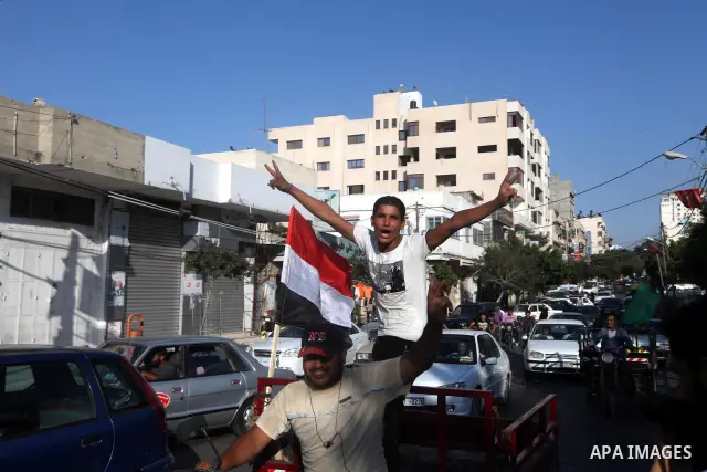 Palestinians hold national and Egyptian flags as they celebrate in Gaza City, the victory of Muslim Brotherhood's presidential candidate, Mohamed Morsi, in the Egyptian elections on June 24, 2012. Arab governments and le...