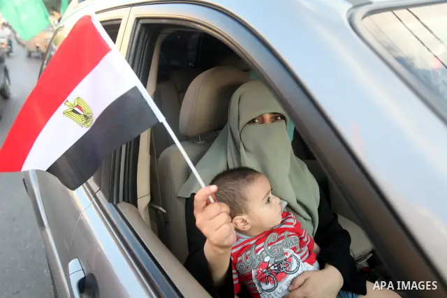 Palestinians hold national and Egyptian flags as they celebrate in Gaza City, the victory of Muslim Brotherhood's presidential candidate, Mohamed Morsi, in the Egyptian elections on June 24, 2012. Arab governments and le...