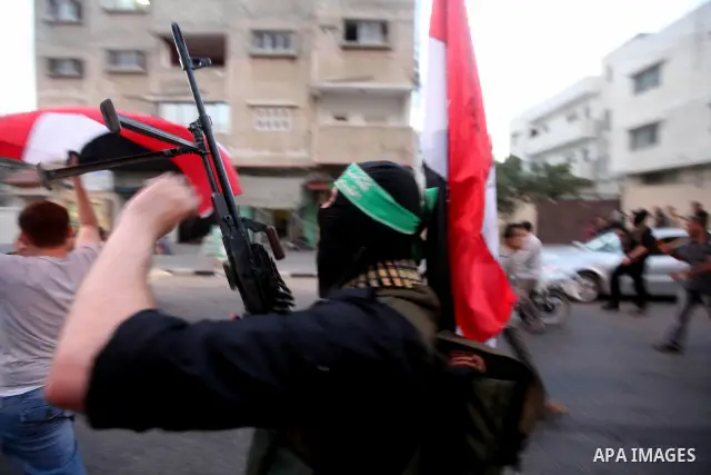 Hamas militants hold a poster depicting Mohamed Morsy of the Muslim Brotherhood after the Egyptian Presidential election committee announced him as victor. The Muslim Brotherhood's Mohammed Morsi became Egypt's first fre...