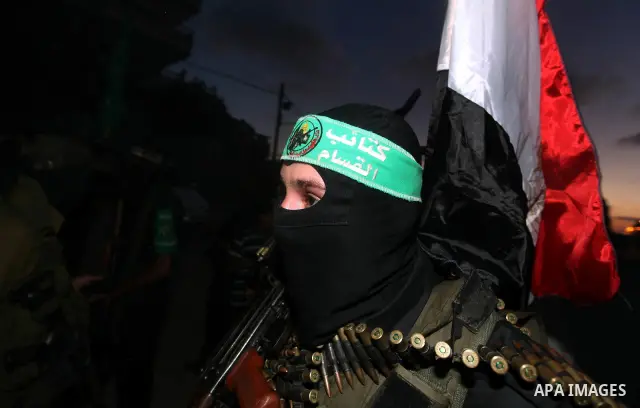 Hamas militants hold a poster depicting Mohamed Morsy of the Muslim Brotherhood after the Egyptian Presidential election committee announced him as victor. The Muslim Brotherhood's Mohammed Morsi became Egypt's first fre...