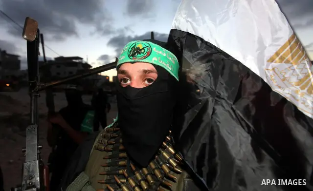 Hamas militants hold a poster depicting Mohamed Morsy of the Muslim Brotherhood after the Egyptian Presidential election committee announced him as victor. The Muslim Brotherhood's Mohammed Morsi became Egypt's first fre...