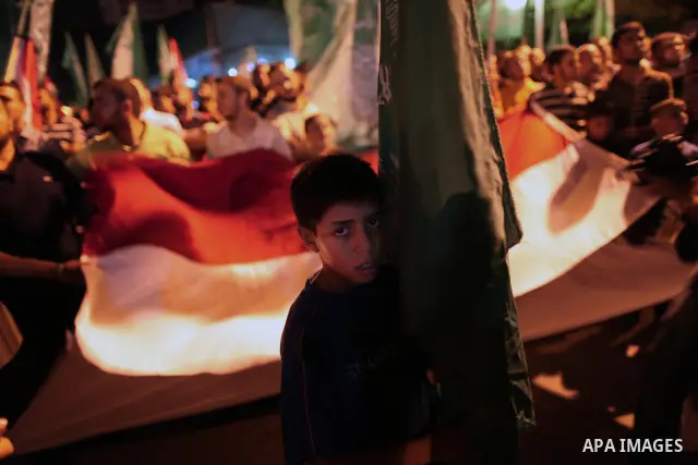Palestinians hold national and Egyptian flags as they celebrate in Gaza City, the victory of Muslim Brotherhood's presidential candidate, Mohamed Morsi, in the Egyptian elections on June 24, 2012. Arab governments and le...