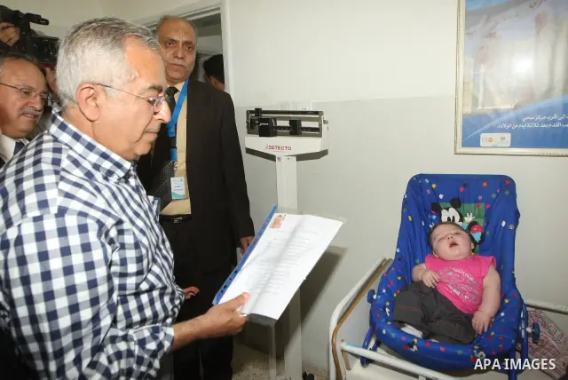 Palestinian Prime Minister, Salam Fayyad attends the opening of several centers in Hebron, in the West Bank of Hebron on June 24, 2012. Photo by Mahmoud Hrebat