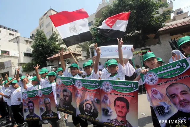 Palestinian boys supporter hold up Egyptian and Palestinian flags during celebrations after Muslim Brotherhood's presidential candidate Mohamed Morsi's victory in the Egyptian elections, Palestinians gather during a prot...