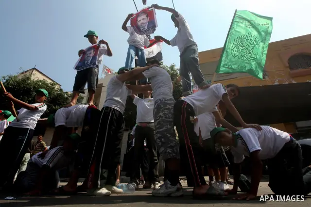Palestinian boys supporter hold flags of Egypt and Hamas during celebrations after Muslim Brotherhood's presidential candidate Mohamed Morsi's victory in the Egyptian elections, Palestinians gather during a protest in fr...