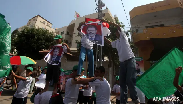 Palestinian boys supporter hold up Egyptian and Palestinian flags during celebrations after Muslim Brotherhood's presidential candidate Mohamed Morsi's victory in the Egyptian elections, Palestinians gather during a prot...