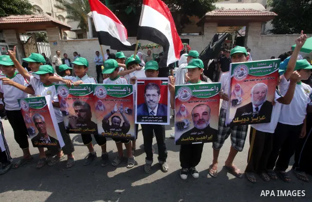 Palestinian boys supporter hold flags of Egypt and Hamas during celebrations after Muslim Brotherhood's presidential candidate Mohamed Morsi's victory in the Egyptian elections, Palestinians gather during a protest in fr...