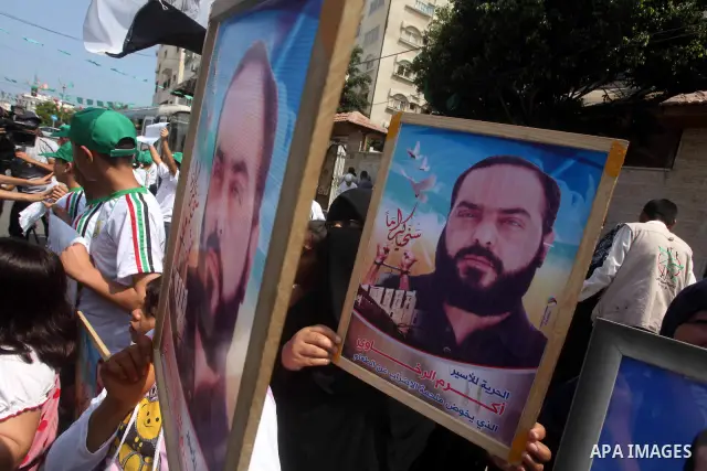 Palestinians gather during a protest in front of the Red Cross' offices in Gaza City to calling of release of palestinian prisoners on June, 25, 2012. Photo by Ashraf Amra