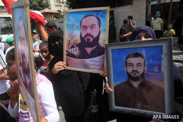 Palestinians gather during a protest in front of the Red Cross' offices in Gaza City to calling of release of palestinian prisoners on June, 25, 2012. Photo by Ashraf Amra