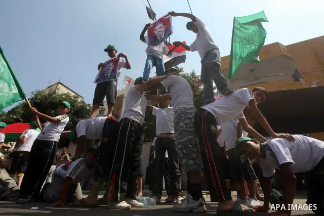 Palestinian boys supporter hold flags of Egypt and Hamas during celebrations after Muslim Brotherhood's presidential candidate Mohamed Morsi's victory in the Egyptian elections, Palestinians gather during a protest in fr...