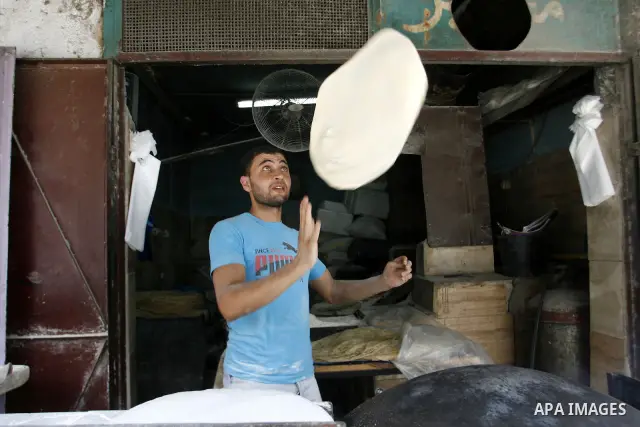 A Palestinian baker prepares bread at his bakery in Rafah, southern Gaza Strip on June 26, 2012. The European Union's envoy to the Palestinian Authority confirmed its support and allegiance to the people. Photo by Eyad A...
