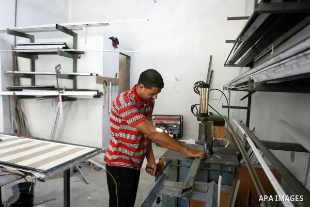 A Palestinian man works in his aluminum factory in Rafah, southern Gaza Strip on June 26, 2012. The European Union's envoy to the Palestinian Authority confirmed its support and allegiance to the people. Photo by Eyad Al...