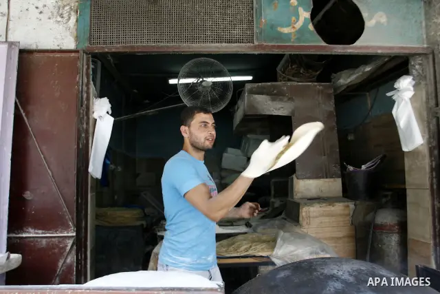 A Palestinian baker prepares bread at his bakery in Rafah, southern Gaza Strip on June 26, 2012. The European Union's envoy to the Palestinian Authority confirmed its support and allegiance to the people. Photo by Eyad A...
