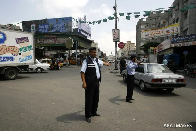 Palestinian policemen organize the traffic,in the southern Gaza Strip town of Rafah, on June 26, 2012. Photo by Eyad Al Baba .