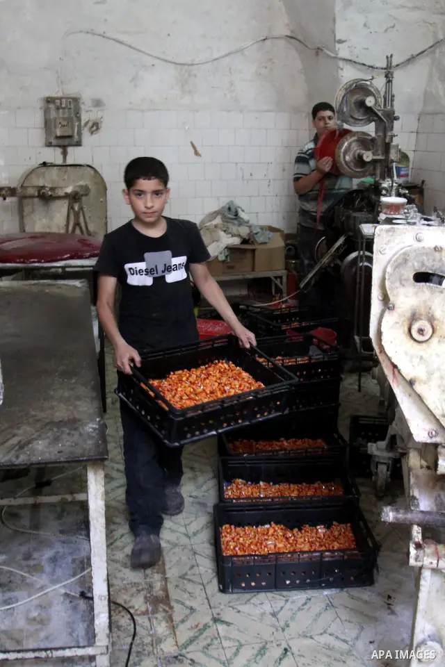 Palestinian labourers work at a factory for making a kind of candy " Toffee" in the West Bank city of Nablus on July 26, 2012. Photo by Nedal Eshtayah