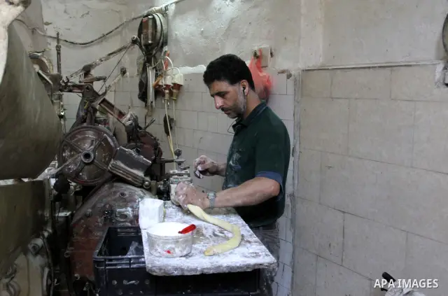 Palestinian labourers work at a factory for making a kind of candy " Toffee" in the West Bank city of Nablus on July 26, 2012. Photo by Nedal Eshtayah