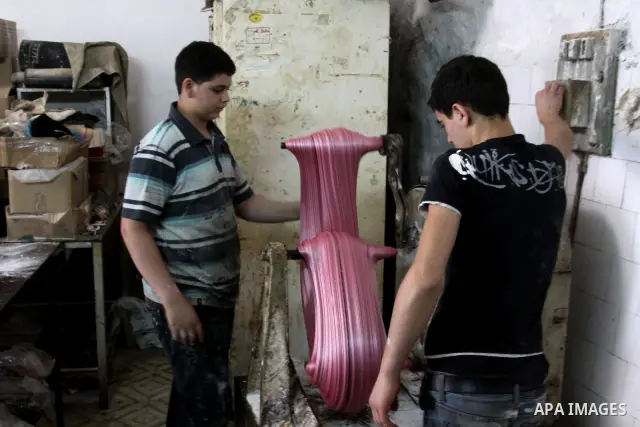 Palestinian labourers work at a factory for making a kind of candy " Toffee" in the West Bank city of Nablus on July 26, 2012. Photo by Nedal Eshtayah