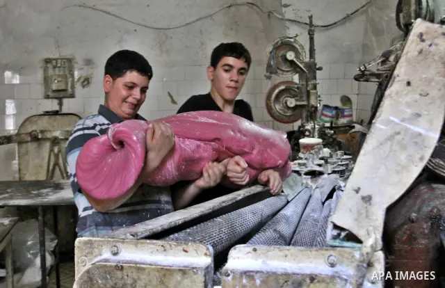 Palestinian labourers work at a factory for making a kind of candy " Toffee" in the West Bank city of Nablus on July 26, 2012. Photo by Nedal Eshtayah