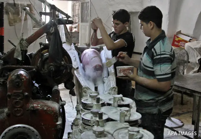 Palestinian labourers work at a factory for making a kind of candy " Toffee" in the West Bank city of Nablus on July 26, 2012. Photo by Nedal Eshtayah