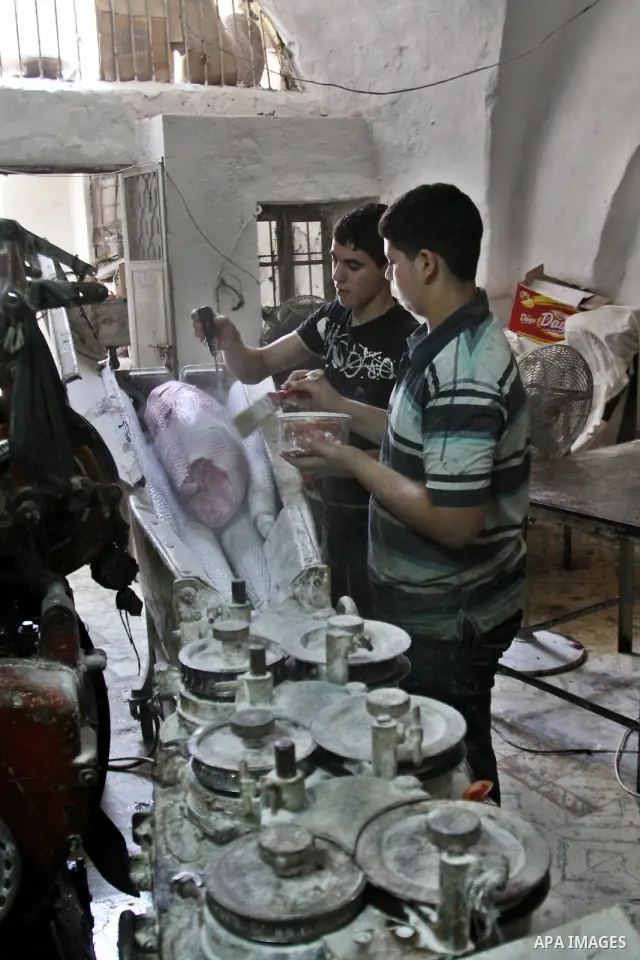 Palestinian labourers work at a factory for making a kind of candy " Toffee" in the West Bank city of Nablus on July 26, 2012. Photo by Nedal Eshtayah